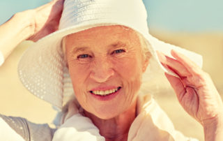 senior woman happy outside with sunhat