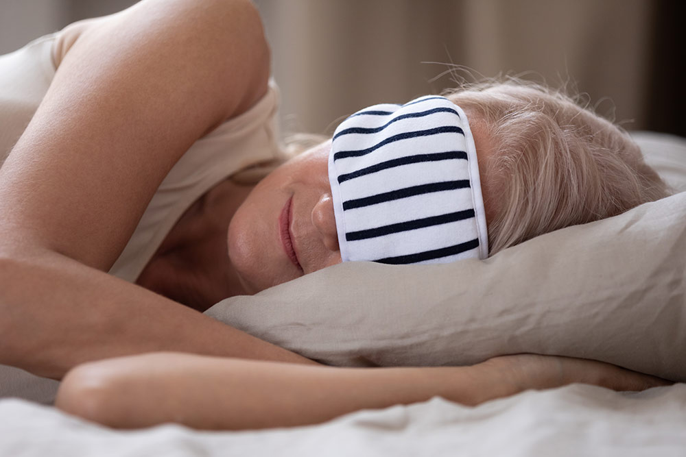 Oakleigh Macomb senior woman sleeping in bed with eye mask