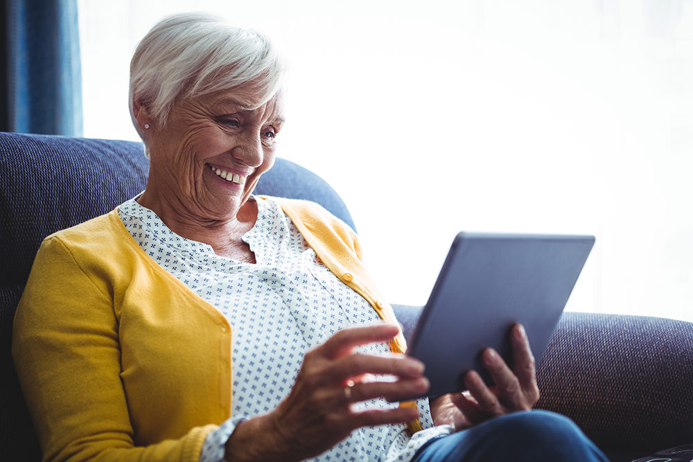 Senior woman looking at digital tablet in hands