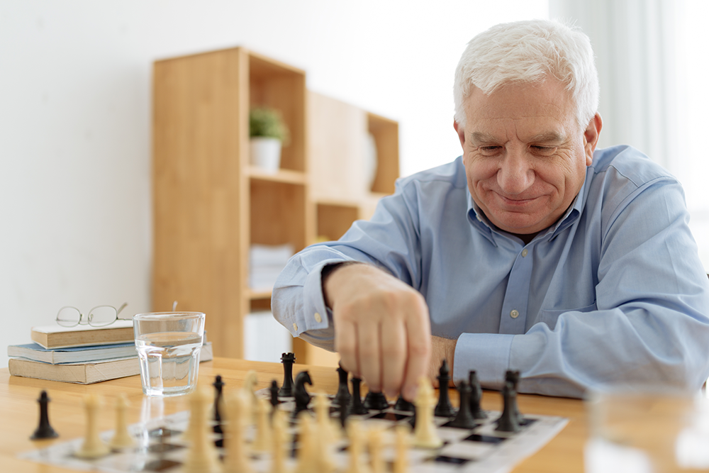 Senior man thinking about his next move in a game of chess Stock Photo by  dmytros9