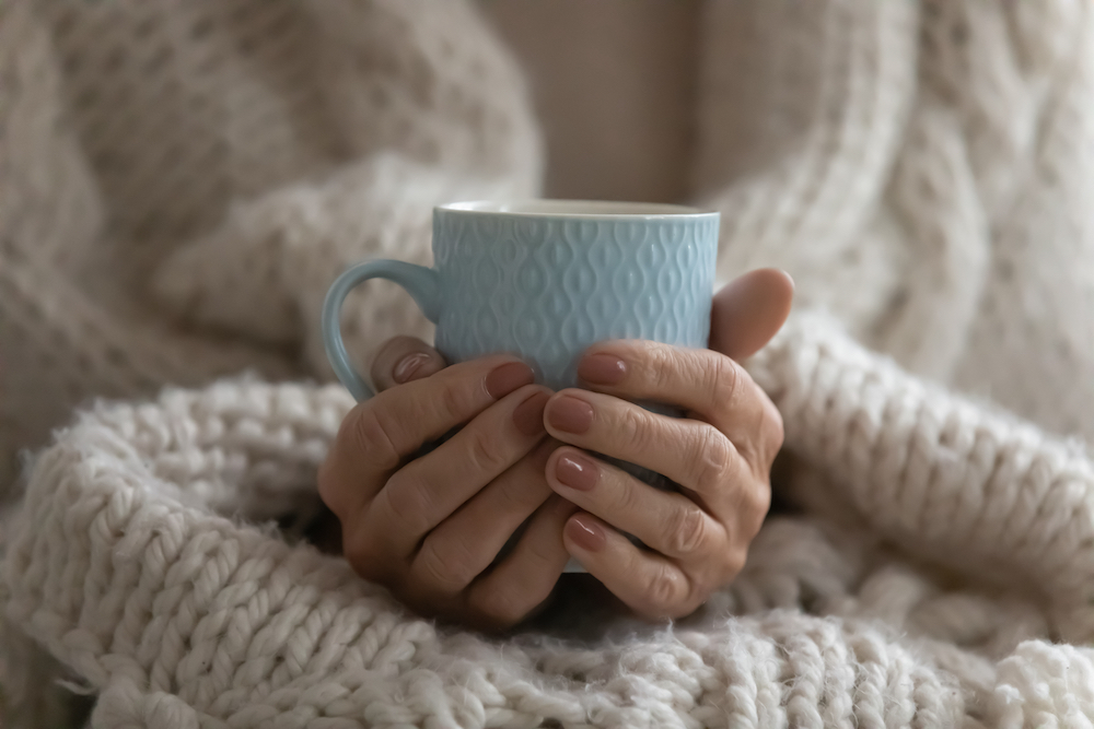 A senior woman holding a mug