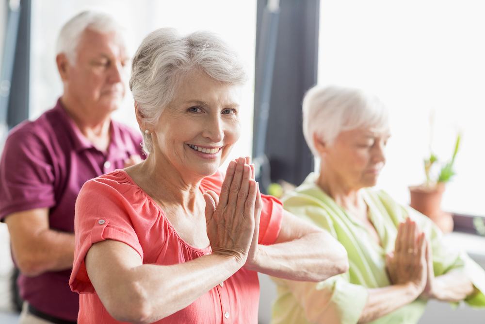 Three seniors at assisted living in Macomb County doing yoga together