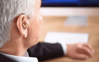 A senior man wearing a hearing aid