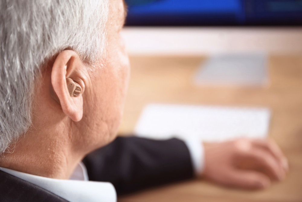 A senior man wearing a hearing aid