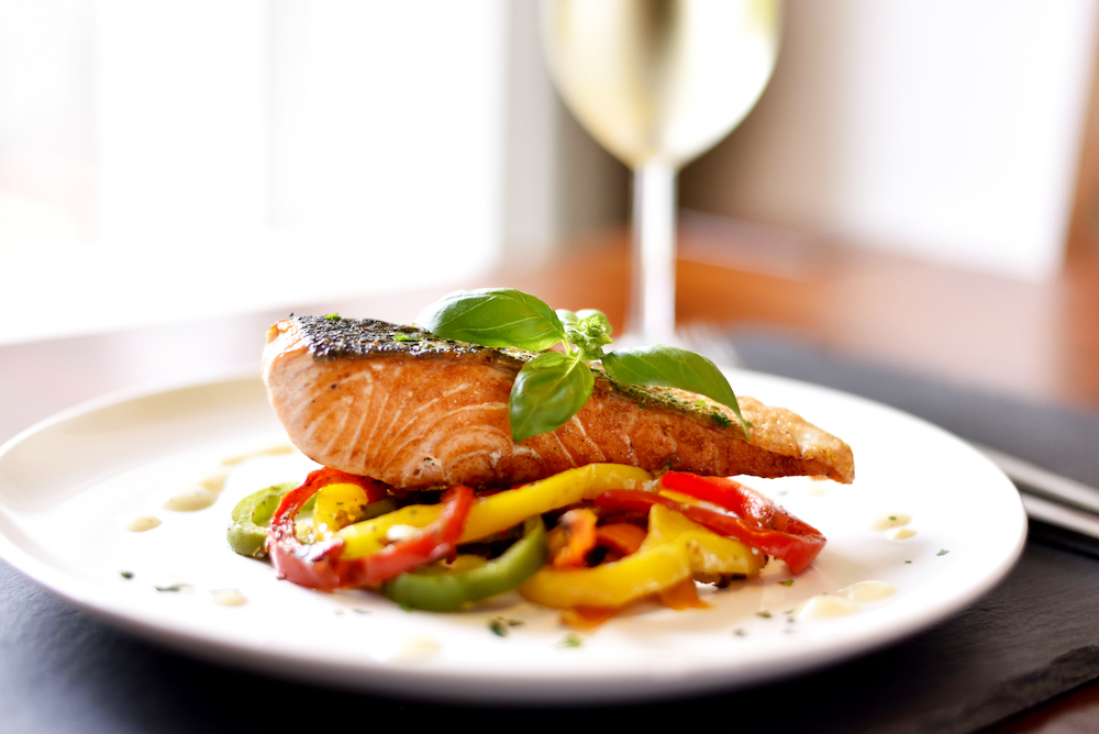 A plate of grilled salmon and peppers