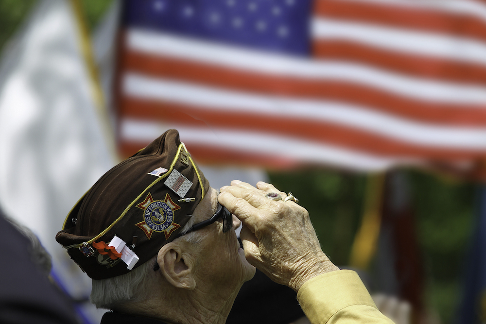 A senior veteran salutes the flag