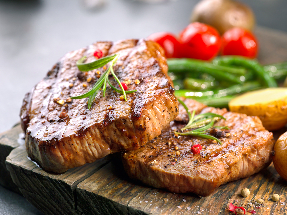 Two grilled steaks with fresh veggies being served at the senior living apartments in Macomb