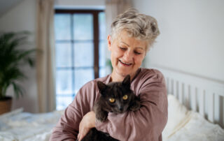 Senior woman with her black cat at senior living apartments macomb