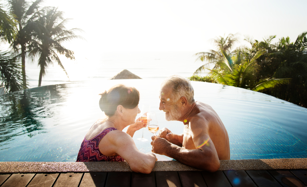 Senior couple in pool in tropical setting