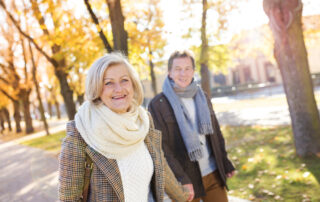 A senior couple on a fall walk outdoors near the best assisted living in Michigan