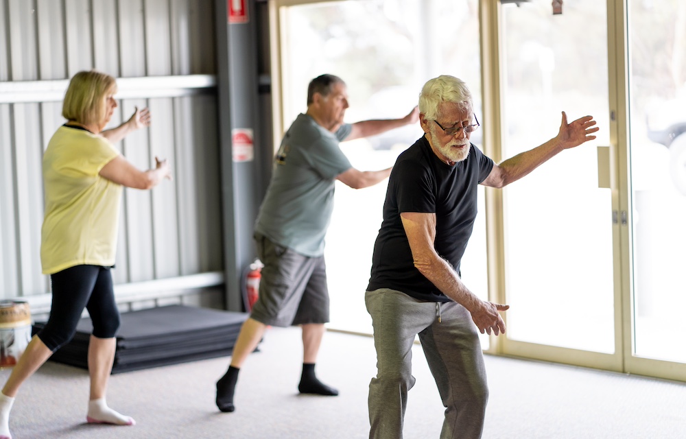 A group of seniors taking a Tai Chi class