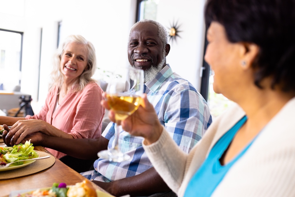 Group of seniors enjoying a dinner together at a retirement communities near me