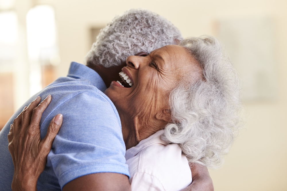 Senior couple hugging and celebrating them looking into retirement communities 